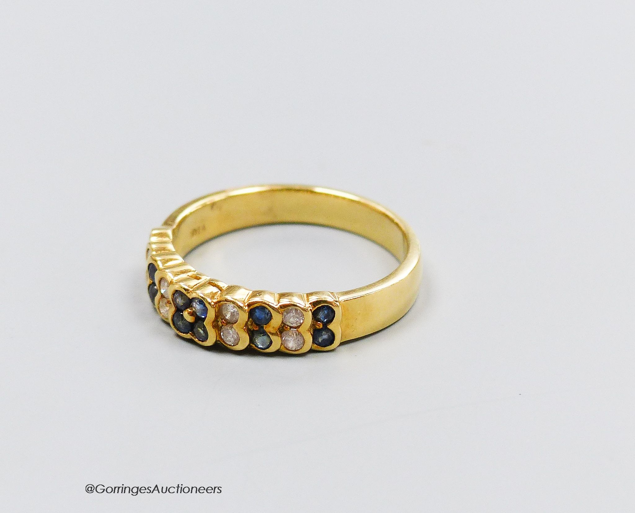 An 18ct gold sapphire and diamond half hoop ring, size R, gross 4g.